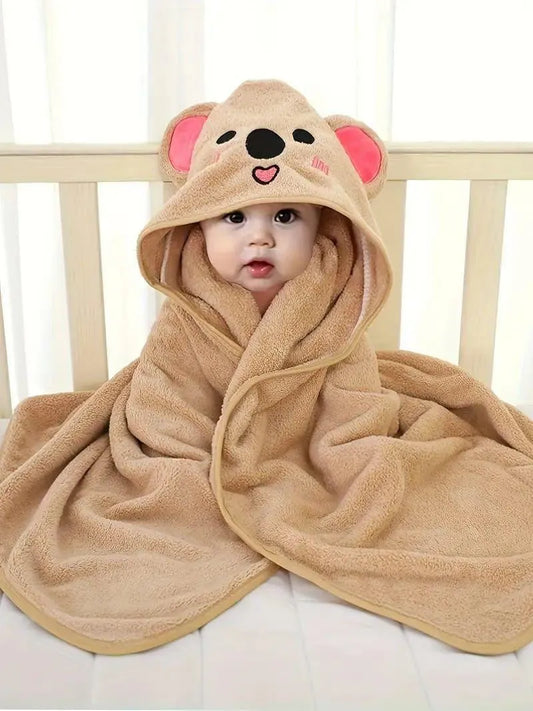 Baby wrapped in a soft beige kids hooded bathrobe animal design resembling a koala with ears and face details