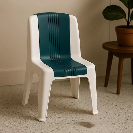 White and green kids plastic chair for toddlers placed indoors on tiled floor with plant in background