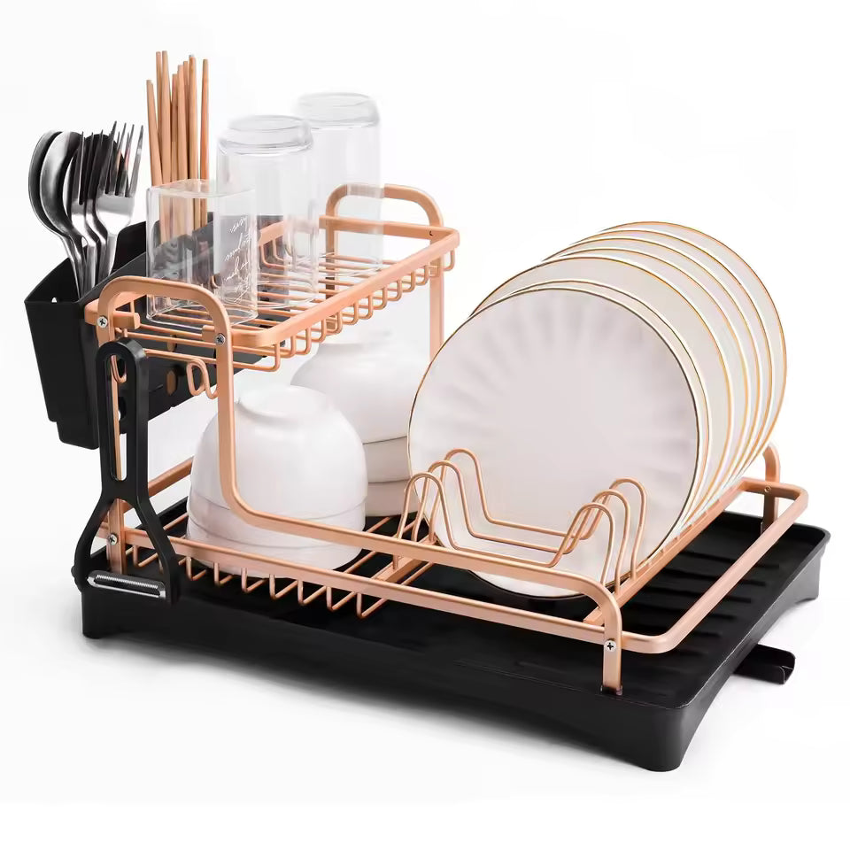 Dish drying rack with cutlery holder in rose gold and black with plates, glasses, and utensils