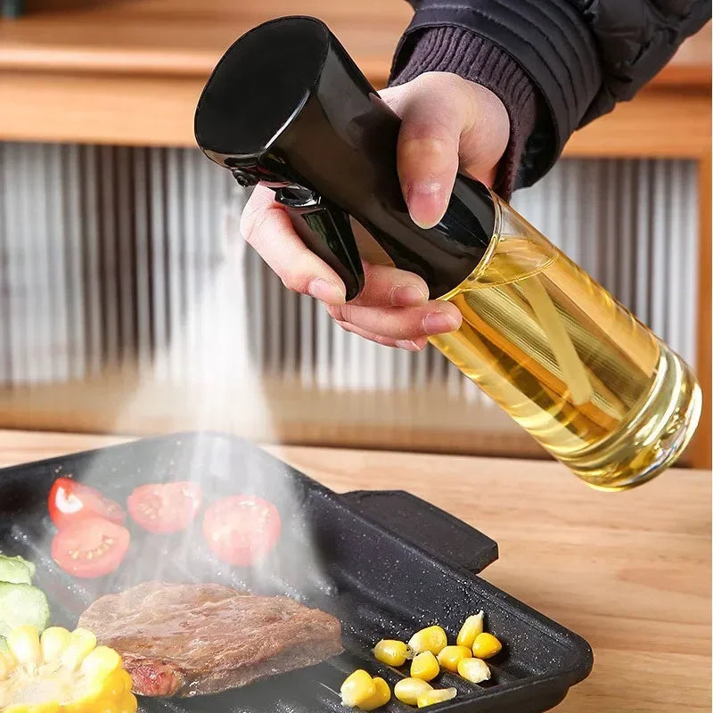 Kitchen oil spray bottle being used to spray oil on steak and vegetables in a black grill pan