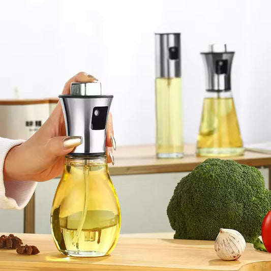 Clarify.pk kitchen oil sprayer for cooking with transparent glass bottle and stainless steel top on wooden countertop