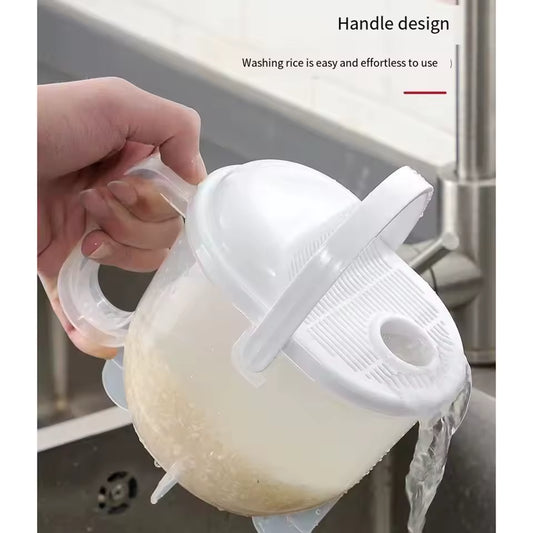 Clear plastic rice strainer with handle draining water over sink with white lid and ergonomic grip
