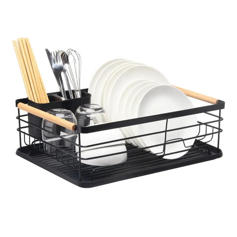 Black iron frame kitchen storage rack with wooden handles holding plates, cutlery, chopsticks, and glasses