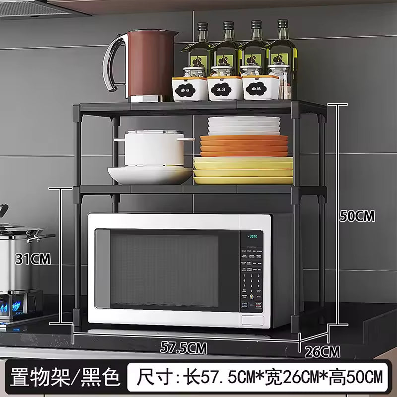 Black kitchen storage rack organizer with three shelves holding microwave, dishes, and bottles on kitchen counter