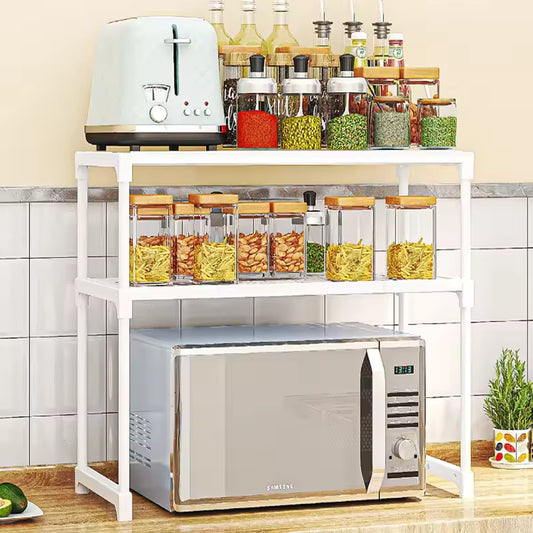 White kitchen storage rack organizer holding jars, bottles, toaster, and microwave on a kitchen counter