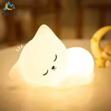 Soft silicone Cat LED lamp night light glowing softly in a cozy room setting by Clarify.pk