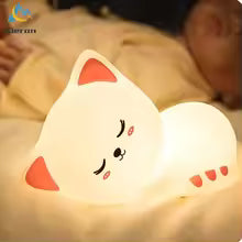 Soft silicone Cat LED lamp night light by Clarify.pk glowing warmly beside a sleeping child