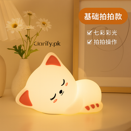 Soft silicone Cat LED lamp night light in sleeping cat shape on a table by Clarify.pk