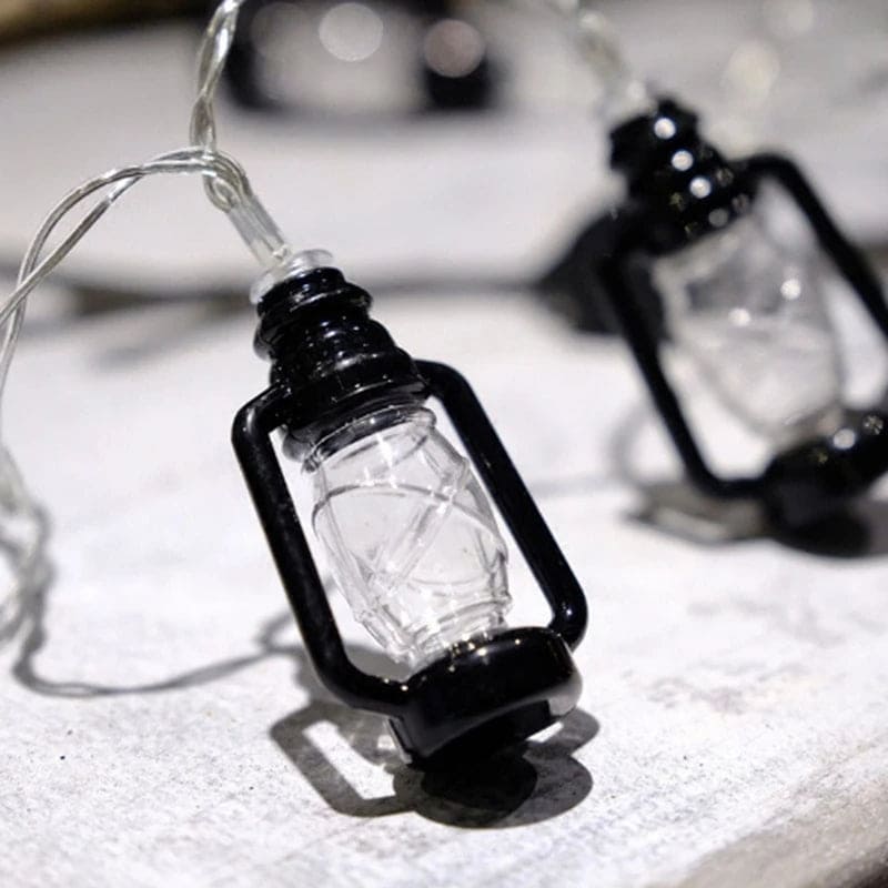 Clarify.pk lantern string lights set with black vintage-style lantern bulbs on clear wire