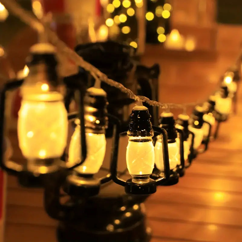 Warm glowing lantern string lights set hanging indoors with vintage black lantern design