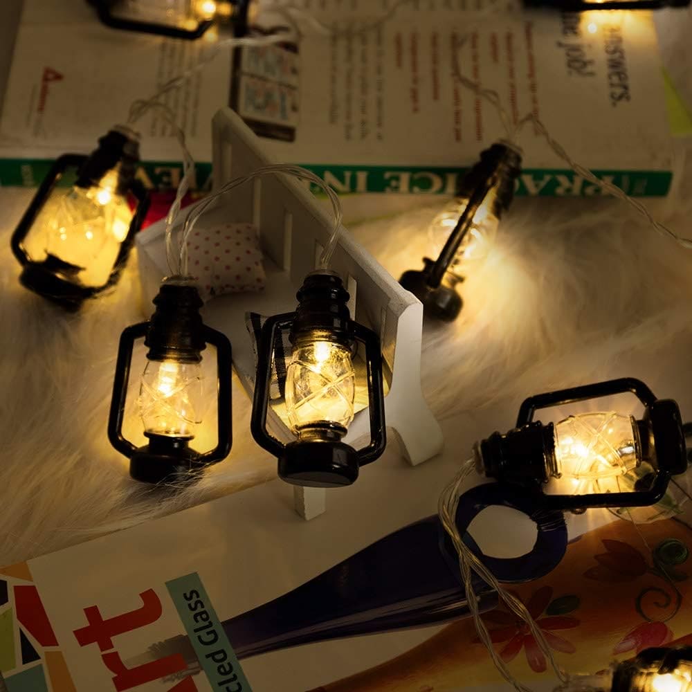Decorative lantern string lights set with warm glowing bulbs on a cozy surface