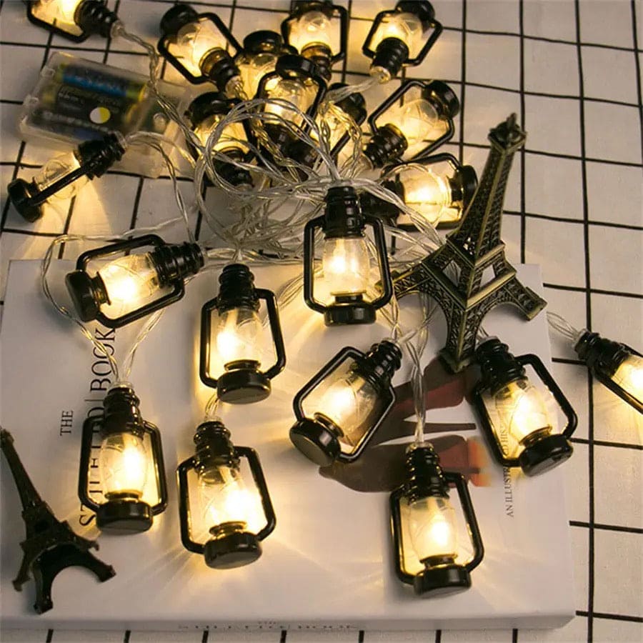 Lantern string lights set with warm glowing mini lanterns on clear wire decoration