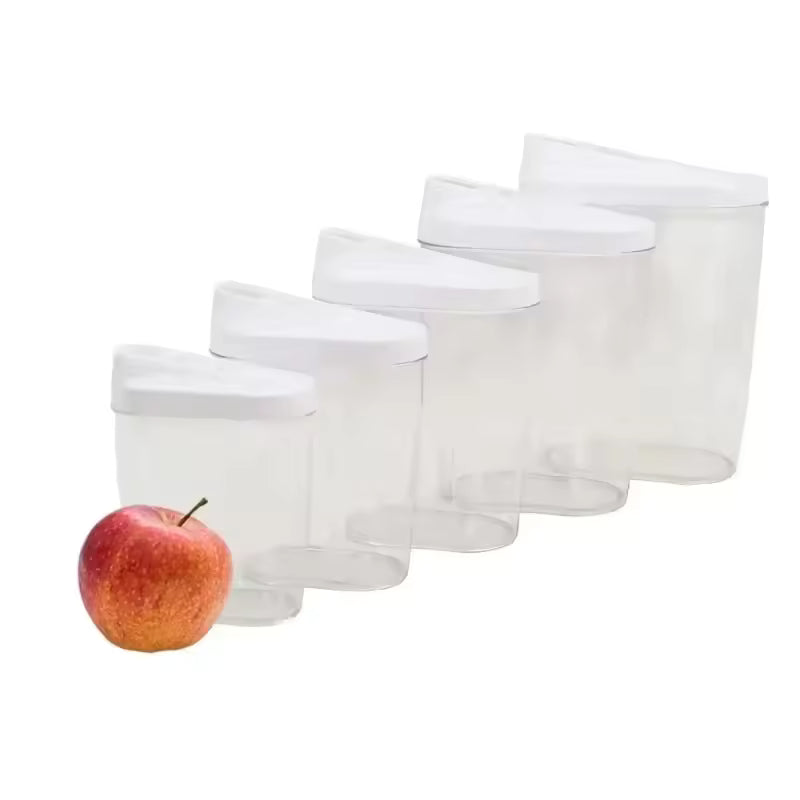 Set of clear large capacity storage jars for pantry with white lids shown with a red apple