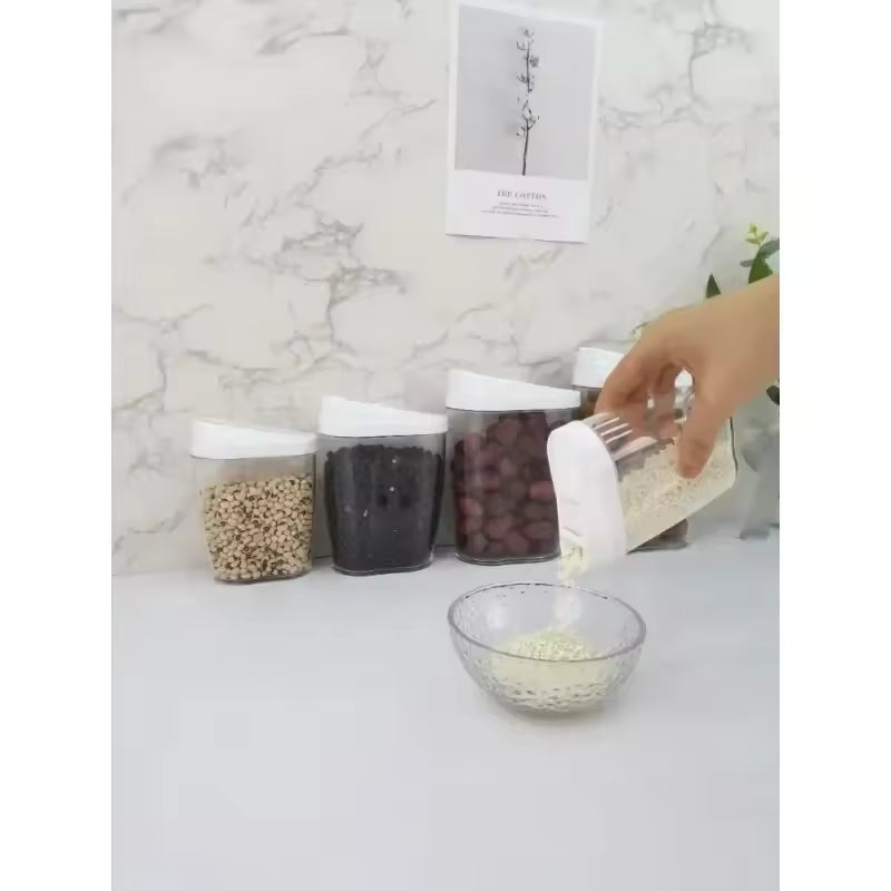 Set of large capacity storage jars for pantry with white lids holding various dry foods on countertop