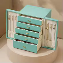 Large faux leather jewelry box in light blue with multiple drawers and side compartments for organizing jewelry