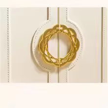 Close-up of a gold decorative clasp on a large faux leather jewelry box by Clarify.pk