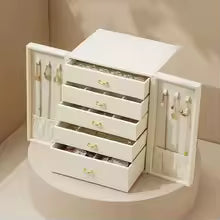 Large faux leather jewelry box with multiple drawers and side compartments for organizing accessories