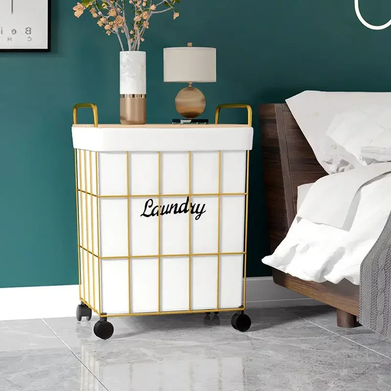 Clarify.pk white laundry basket with gold frame and laundry basket with wheels beside bed in modern room