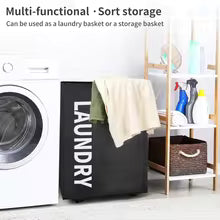 Clarify.pk black laundry storage basket with white text beside washing machine for organizing clothes