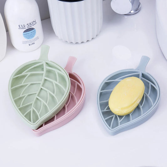 Clarify.pk leaf shape soap dish in pastel colors holding yellow soap on white bathroom counter