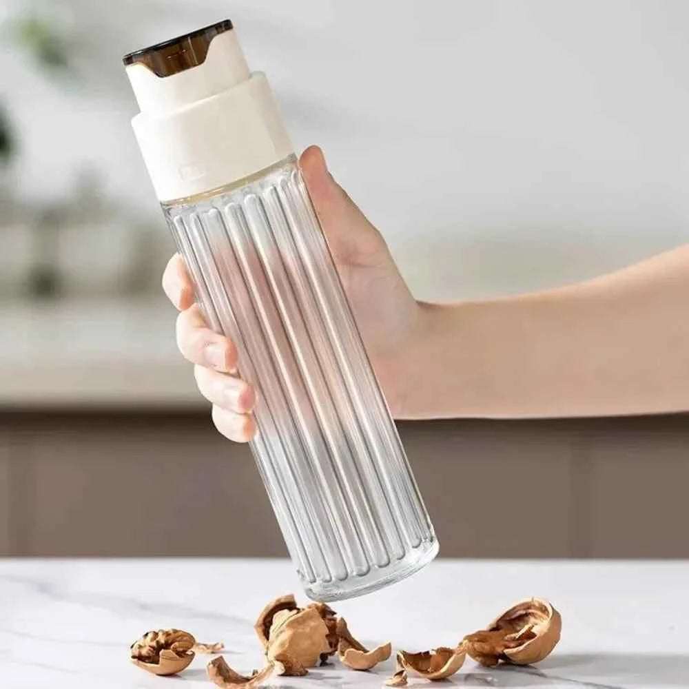 Transparent leak-proof glass oil jar with easy-pour spout, ideal for kitchen storage