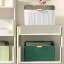 Leakproof first aid kit box by Clarify.pk in white and green colors placed on shelves for organized storage