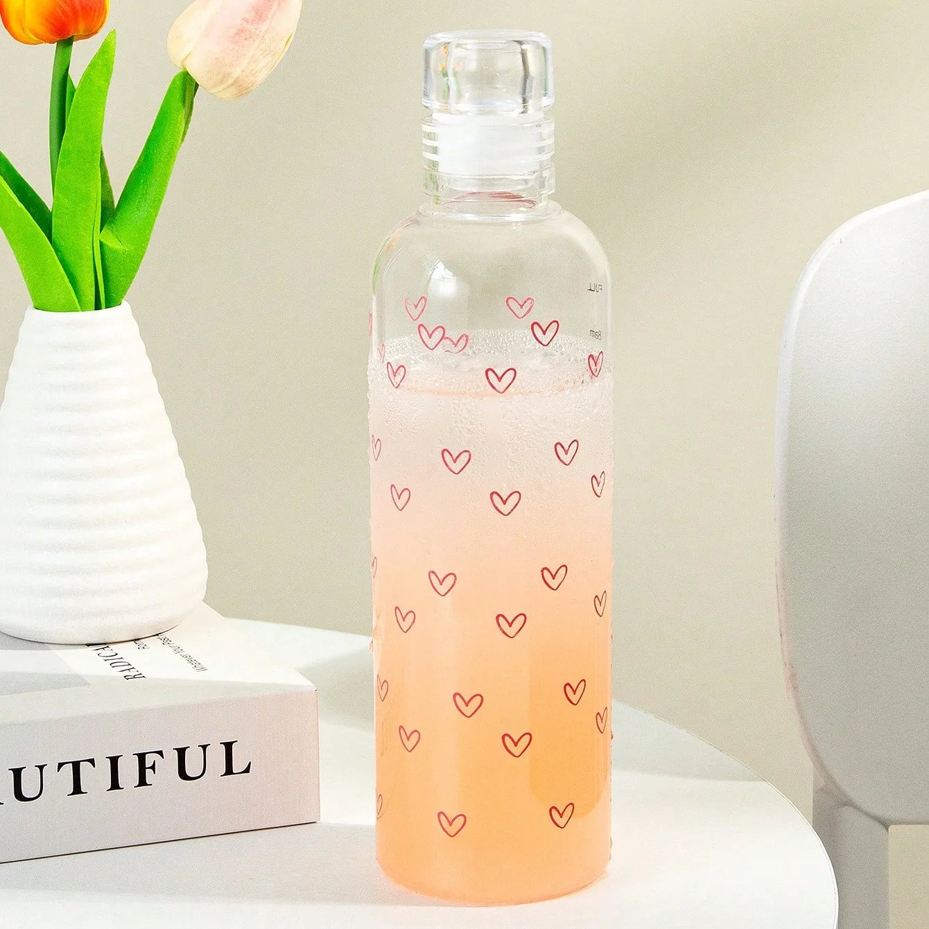 Clarify.pk leakproof sport water bottle with heart print design filled with orange drink