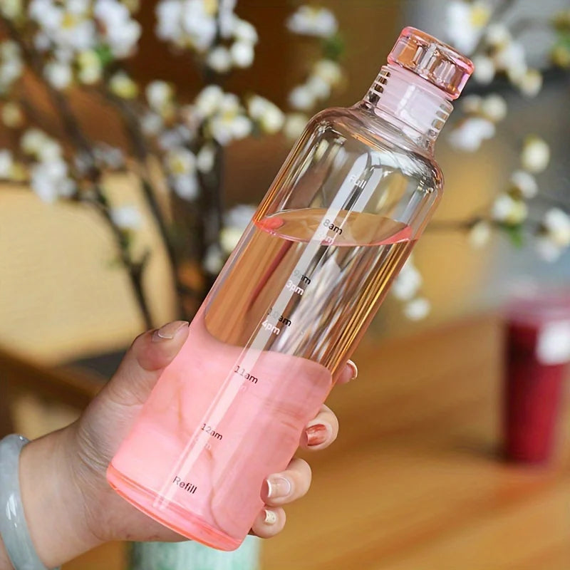 Clarify.pk leakproof sport water bottle in clear pink held in hand with measurement markings