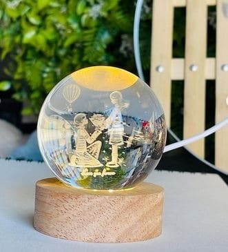 Clarify.pk LED astronomy night light with wooden base showing romantic couple design inside glowing globe