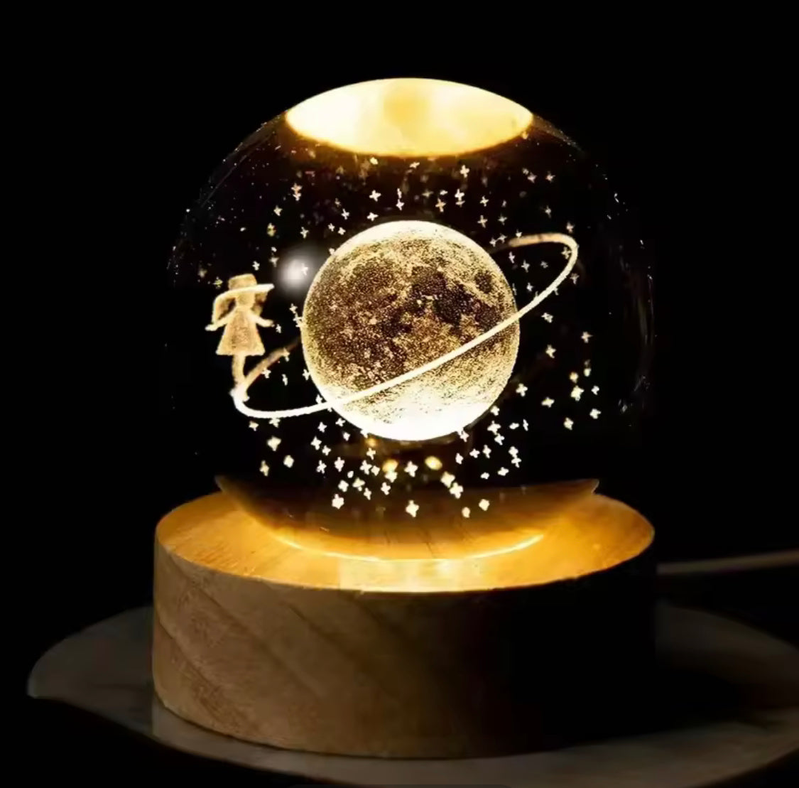 Clarify.pk LED astronomy night light with glowing planet, stars, and girl figure on wooden base