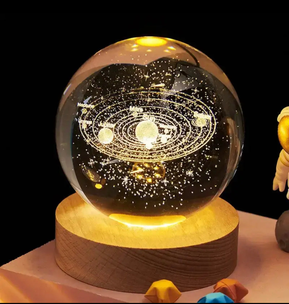 LED astronomy night light globe with solar system design on wooden base glowing in dark