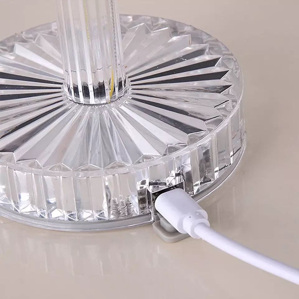 Base of led crystal projection lamp with clear crystal design and white USB charging cable connected