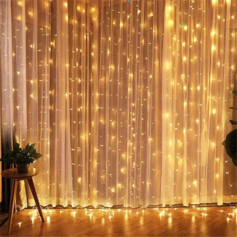 Warm white LED curtain lights for home decor hanging on sheer curtains in a cozy living room