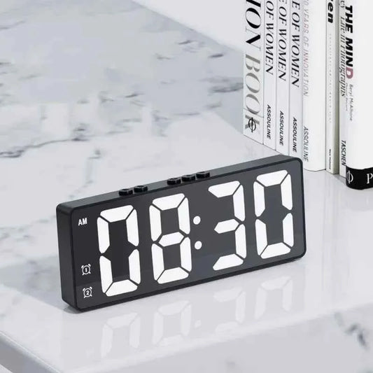 LED digital alarm clock displaying the time 08:30 on a stylish marble surface