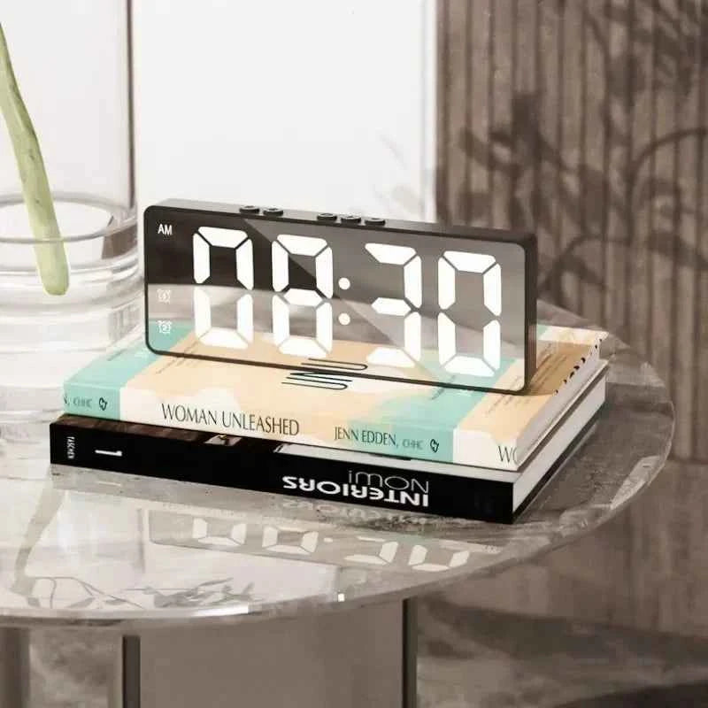 Stylish LED digital alarm clock displaying 08:30 on a modern bedside table