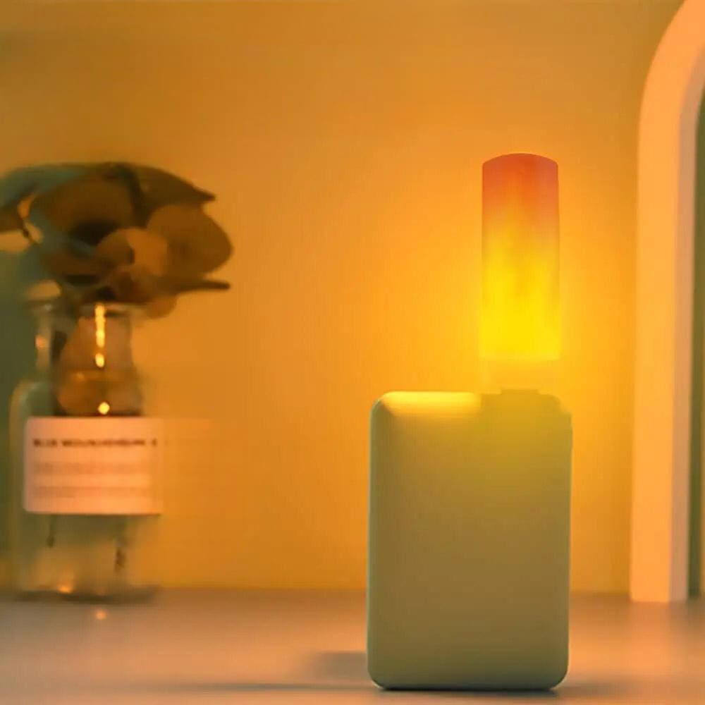 Clarify.pk LED flame effect night light glowing with warm yellow light on a nightstand