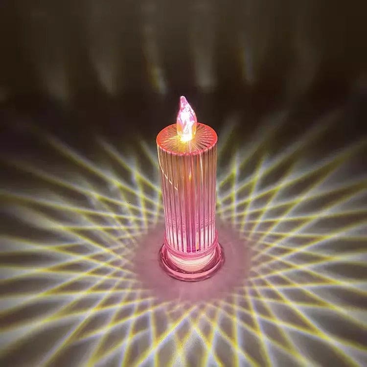 Pink LED flameless candle lamp casting decorative light patterns on a dark surface