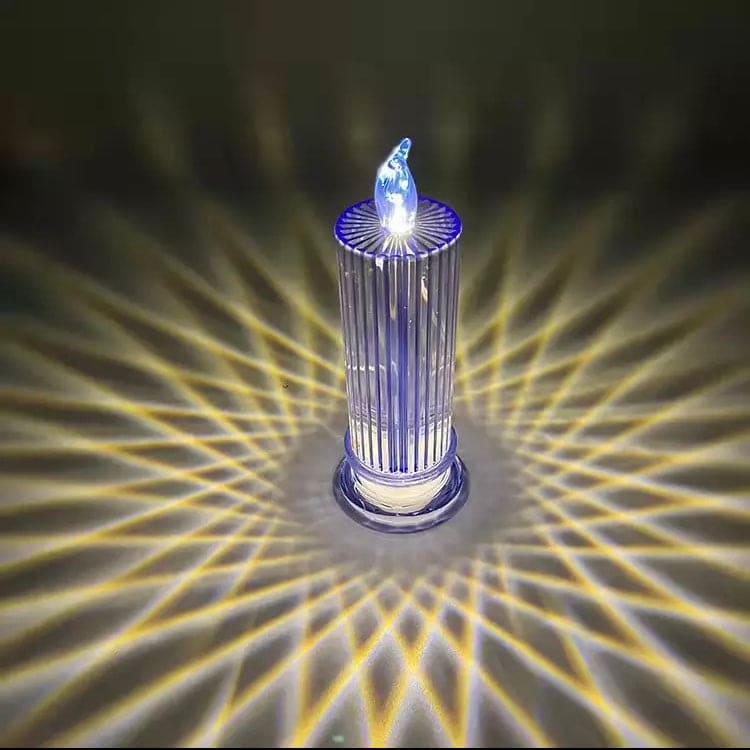 Transparent LED flameless candle lamp projecting decorative light patterns on the surface