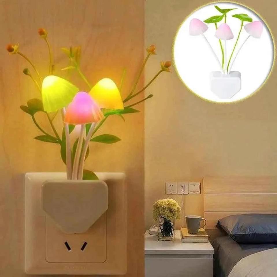 Home de LED mushroom night light with colorful glowing caps plugged into a wall socket in bedroom