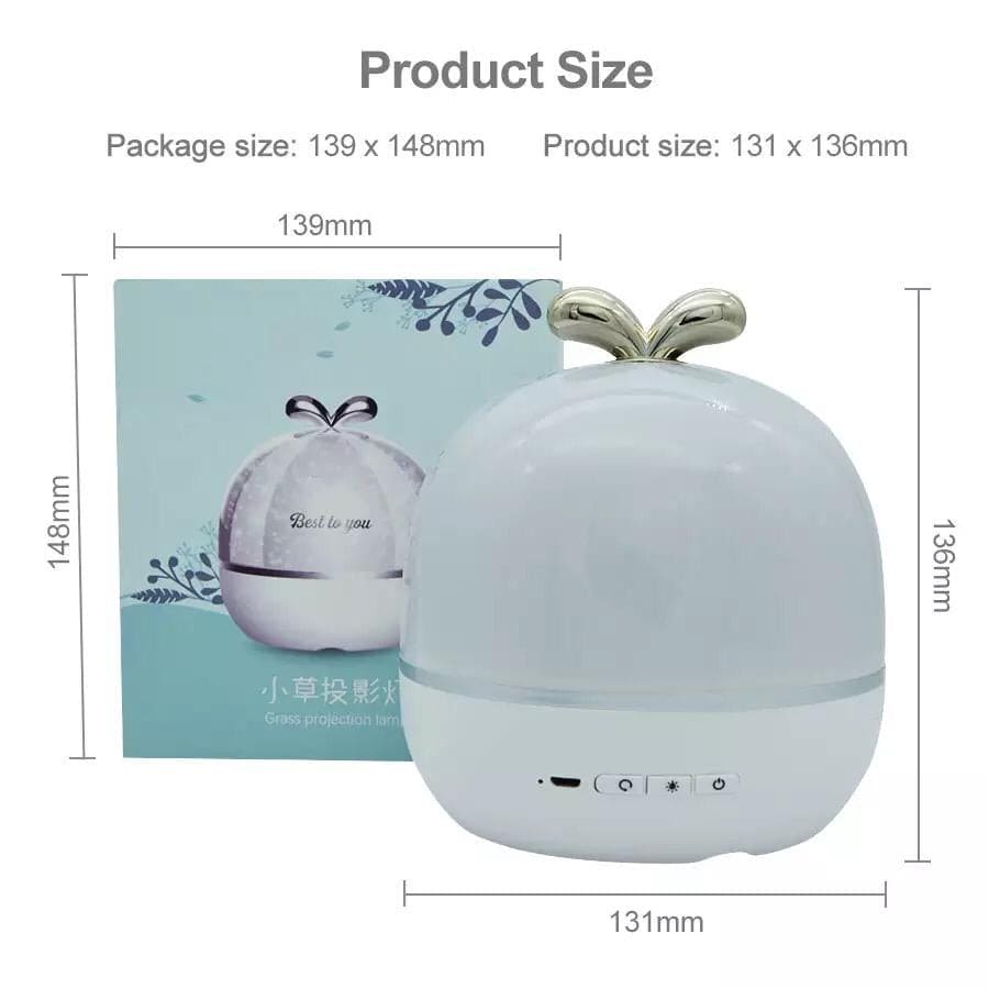 Compact LED night light projector with gold leaf design and control buttons, packaging shown behind
