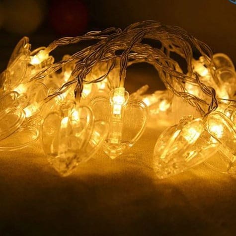 Warm white LED photo clip string lights with transparent heart-shaped clips for hanging photos