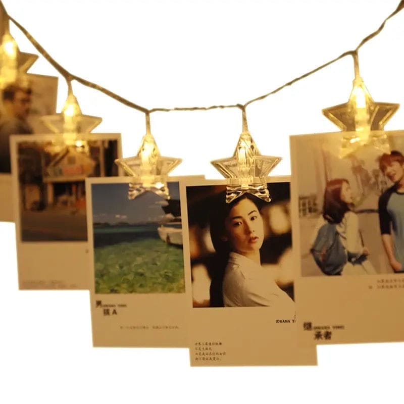 Warm glowing LED photo clip string lights with star-shaped clips holding photos