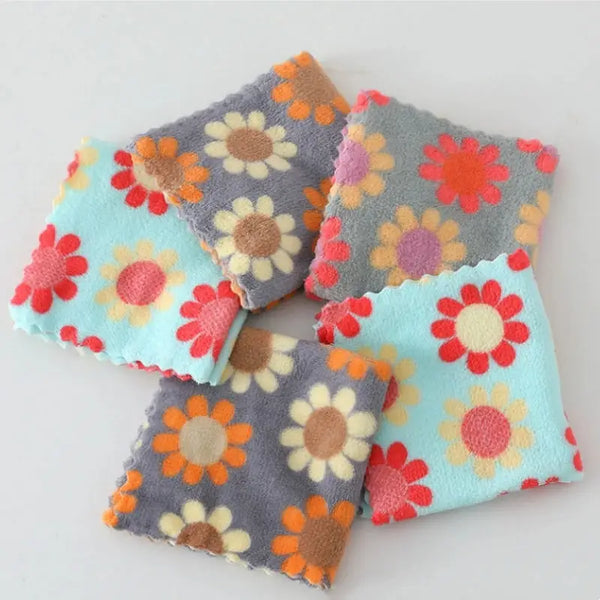 Pack of floral cotton face towels in pastel blue and gray featuring daisy prints and scalloped edges