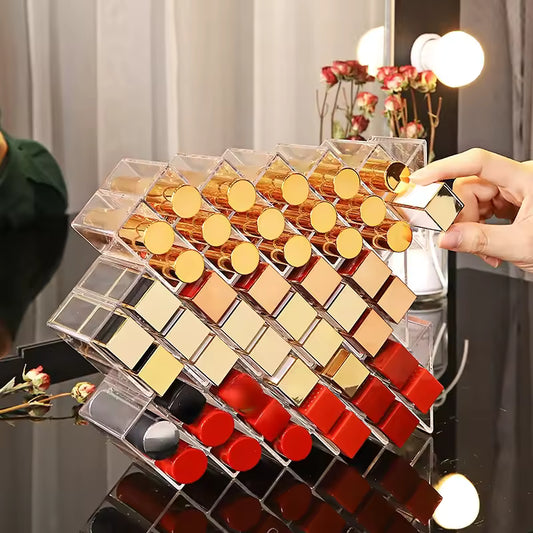 Clear lipstick organizer with compartments holding various lipsticks on a black glossy surface