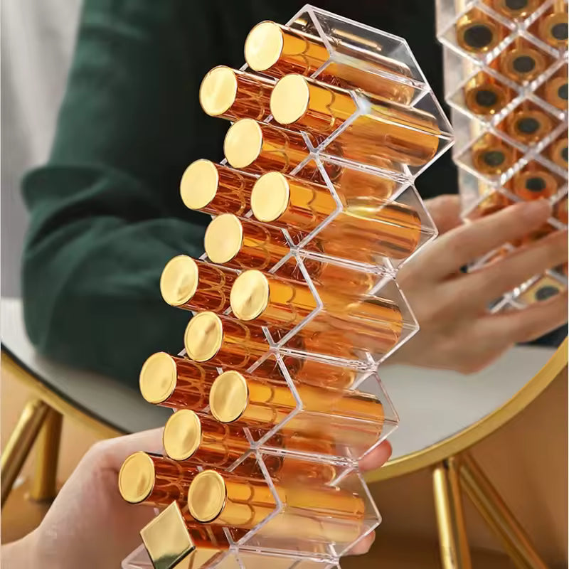 Clear lipstick organizer with compartments holding multiple gold-capped lipsticks for makeup storage