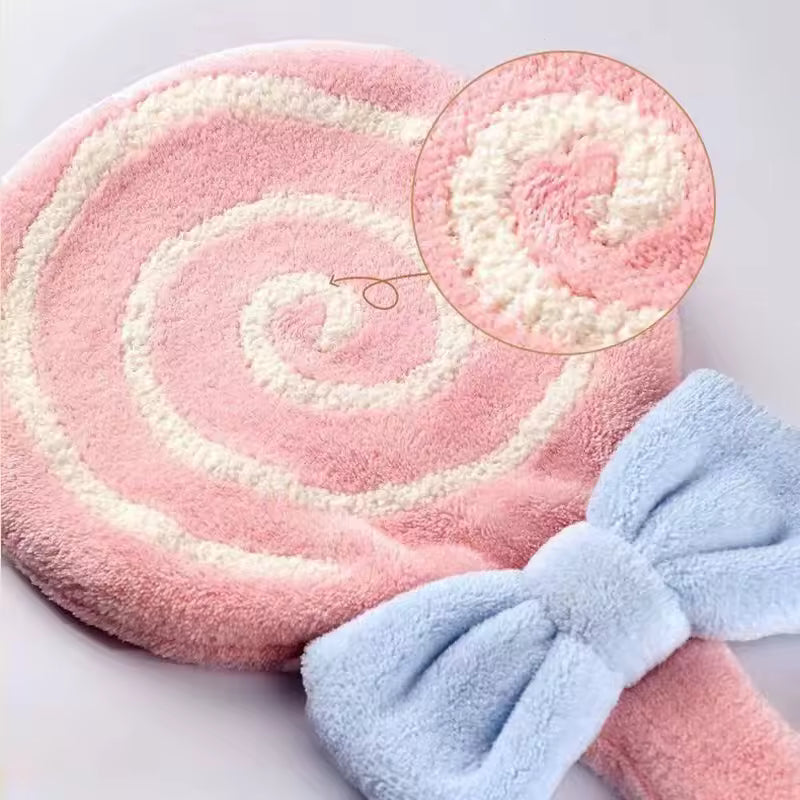 Pink and white lollipop design bathroom towel with soft texture and blue bow detail by Clarify.pk