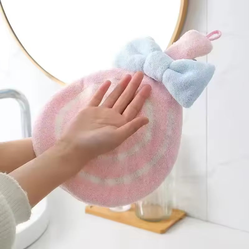 Clarify.pk lollipop design bathroom towel in pink and white with blue bow held near sink