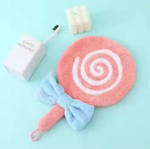 Pink lollipop design bathroom towel with white swirl and blue bow by Clarify.pk on blue background
