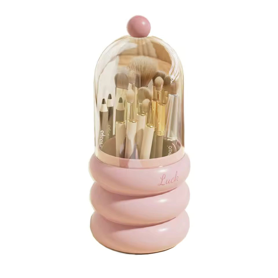 Pink dustproof makeup organizer with lid holding various makeup brushes and pencils