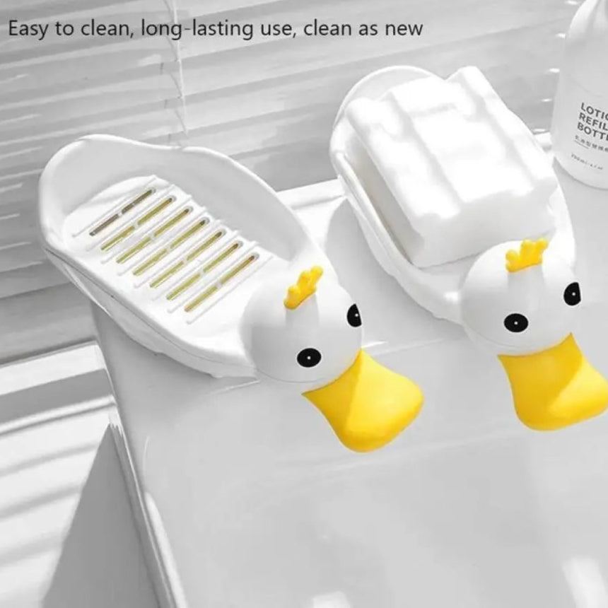 White and yellow cartoon duck soap dish with drainage grooves for easy cleaning on bathroom sink